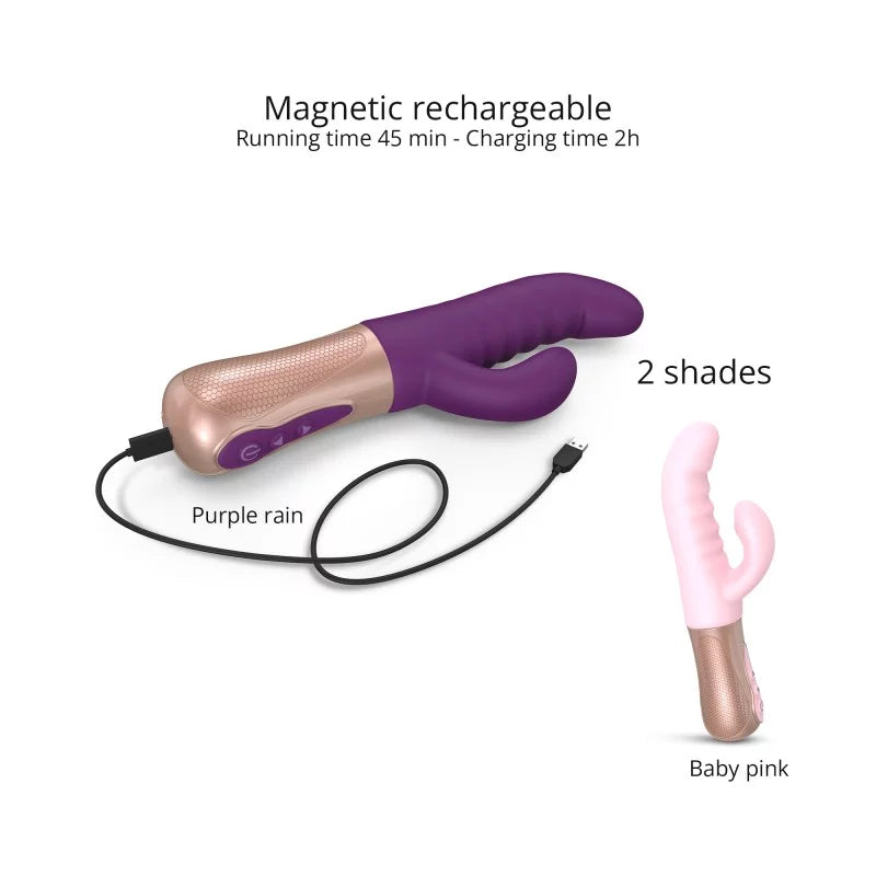A pink and beige rabbit vibrator with dual stimulation design, displayed alongside its box and a black storage pouch. The product has a curved silicone shaft and a smaller attachment for clitoral stimulation.