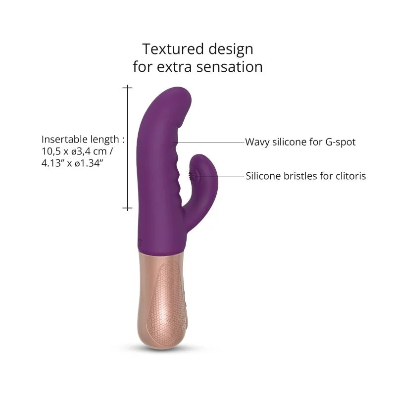 A purple and beige rabbit vibrator with dual stimulation design, displayed alongside its box and a black storage pouch. The product has a curved silicone shaft and a smaller attachment for clitoral stimulation.