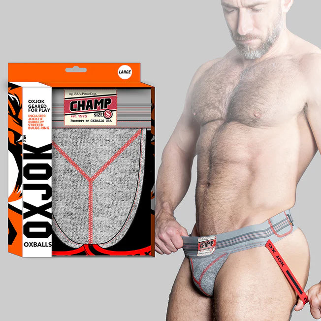 Man wearing gray underwear with red accents, holding the product packaging.