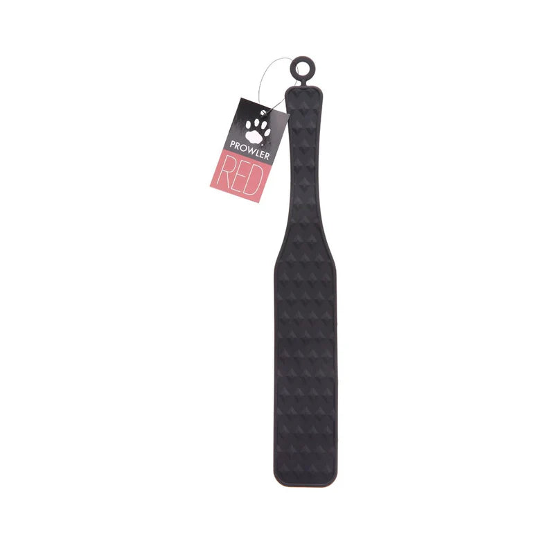 black silicone paddle for impact play with studded pattern.