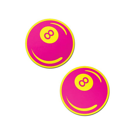 a pair of neon pink and yellow 8 ball nipple pasties