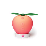 A peach shaped massager in its usb rechargeable docking station