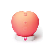 A peach shaped massager in its usb rechargeable docking station