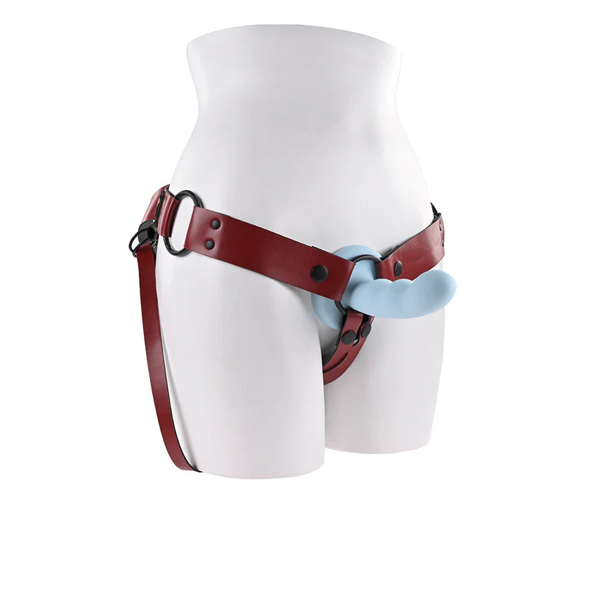 Mannequin wearing a red leather harness with blue plastic parts on a white background