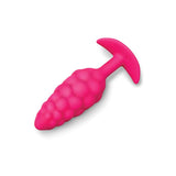 pink silicone t base vibrating butt plug with bump texture from b-vibe